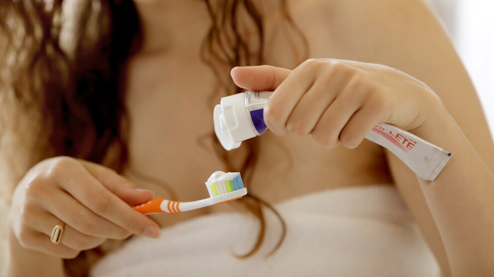 Woman Applies Toothpaste