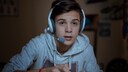 A teenager plays on the computer