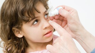 Girl Receives Eye Drops