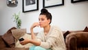 A thoughtful woman on a sofa