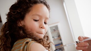 A girl is being vaccinated