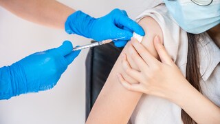 A teenager is being vaccinated