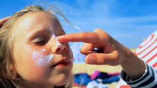 Girl Gets Sunscreen Applied to Her Face