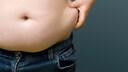 Children's Obesity and the Brain: Young Boy Pinches His Side