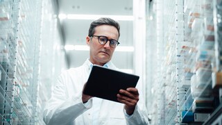 Pharmacist in Front of Medication Shelf