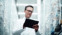 Pharmacist in Front of Medication Shelf