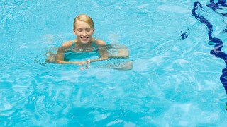 Woman Swims in Pool