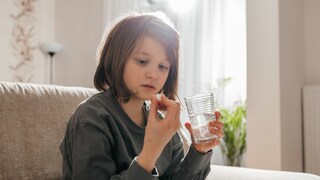 Girl Takes a Children's Dietary Supplement