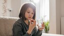 Girl Takes a Children's Dietary Supplement