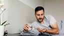 Man Takes Melatonin Tablet