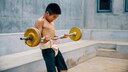 A young man is doing strength training.
