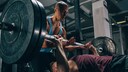 Two Men Lifting Weights at the Gym