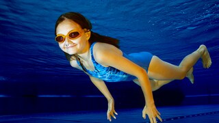 A girl swims in a pool