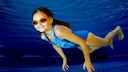 A girl swims in a pool