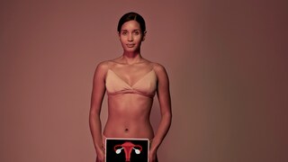 Woman holding a picture of the female sexual organ.
