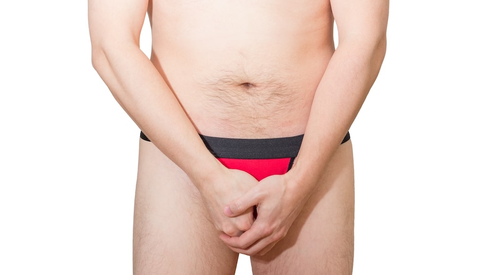 Man grabs his crotch