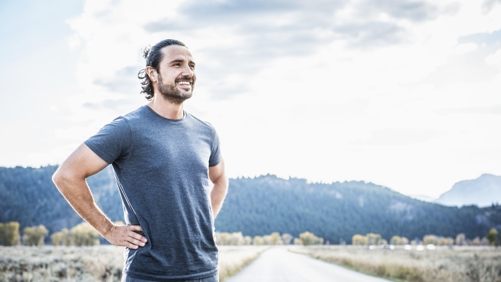 Man stands laughing, possibly with a strong immune system