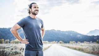 Man stands laughing, possibly with a strong immune system