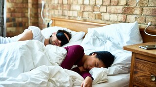 Couple catching up on sleep at the weekend