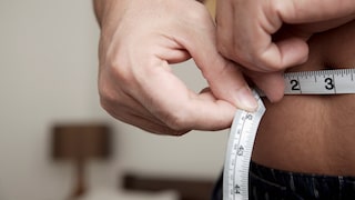 Person measures waist circumference