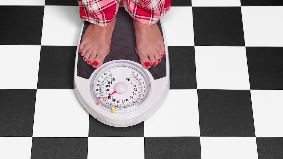 A woman weighs herself