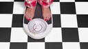 A woman weighs herself