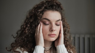 Woman touches her face