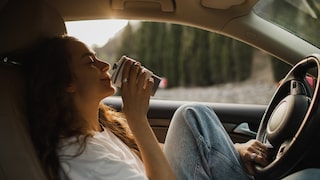 A woman drinks coffee