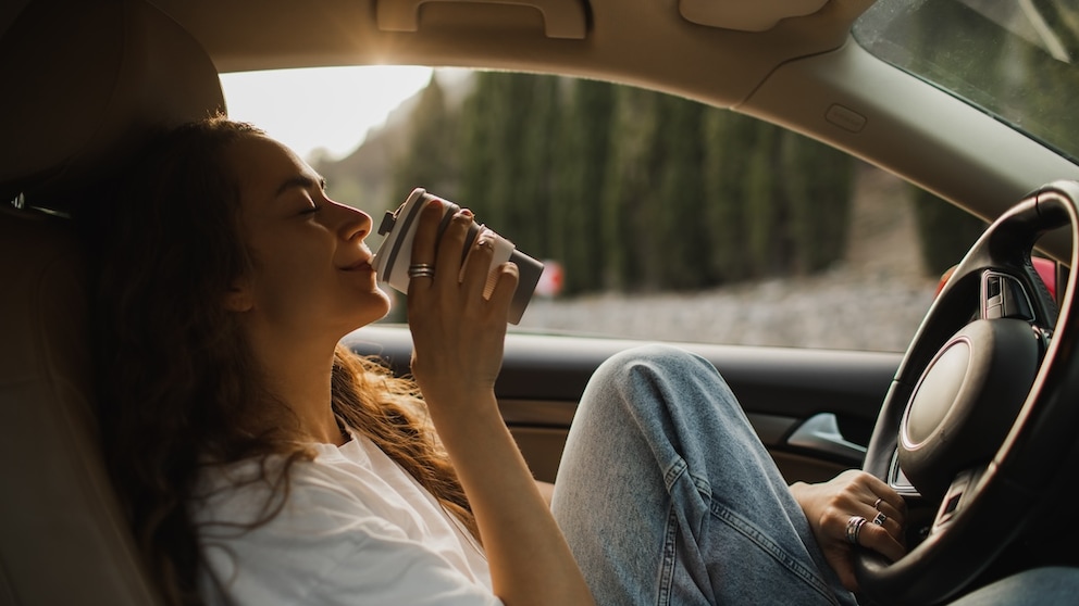 A woman drinks coffee