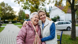 Two women hugging outside.