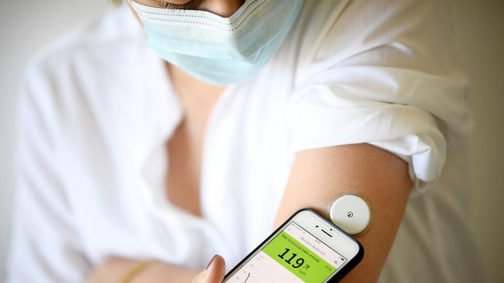 Woman with diabetes measures her blood sugar level