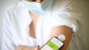 Woman with diabetes measures her blood sugar level