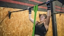 Woman doing pull-ups with band