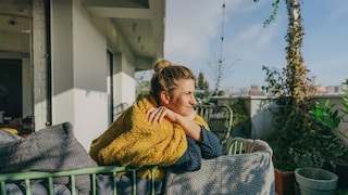 Woman holding her face in the spring sun