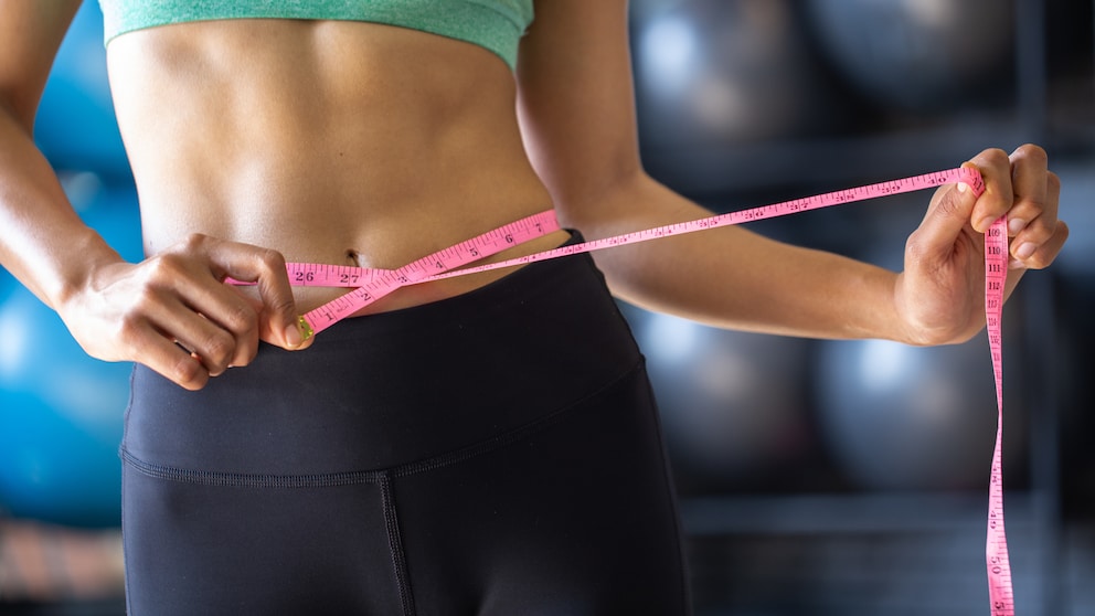 To achieve a flat stomach, start by working out your legs and glutes—not just with sit-ups.