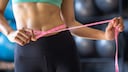 To achieve a flat stomach, start by working out your legs and glutes—not just with sit-ups.