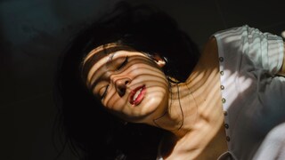 Sweating is often part of the menstrual period, as a woman lies down and appears to be sweating.