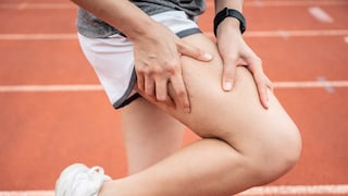 Person Grabs Their Thigh