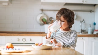 Child Drinks a Glass of Milk