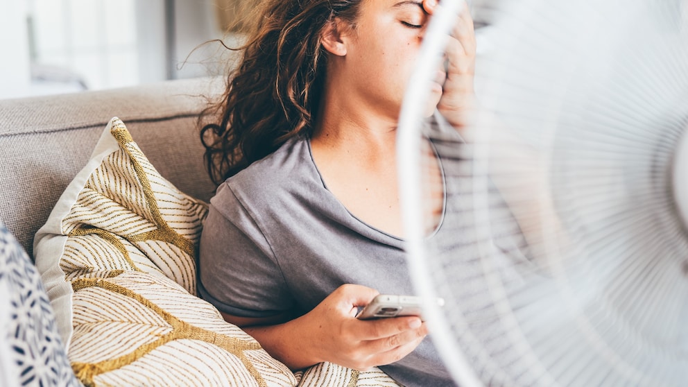 Woman Overheats in Front of Fan