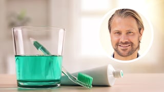 A glass of mouthwash and a toothbrush