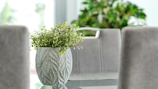 Artificial houseplants: A green artificial houseplant in a gray flower pot