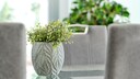 Artificial houseplants: A green artificial houseplant in a gray flower pot