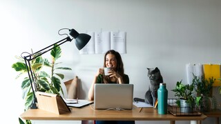 A woman sits at her desk.