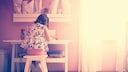 Child Sitting at a White Desk