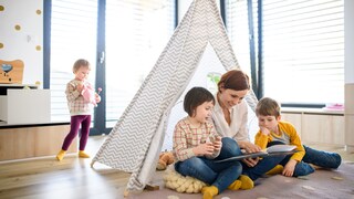 Mother Reading a Book with Her Children in a Cozy Teepee