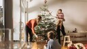 Family Sets Up Christmas Tree