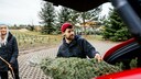 Man Loads Christmas Tree into Car