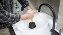 If the drain is clogged, you can use a plunger to help clear it.