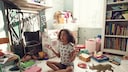 Little girl seemingly meditating amid the chaos of her playroom